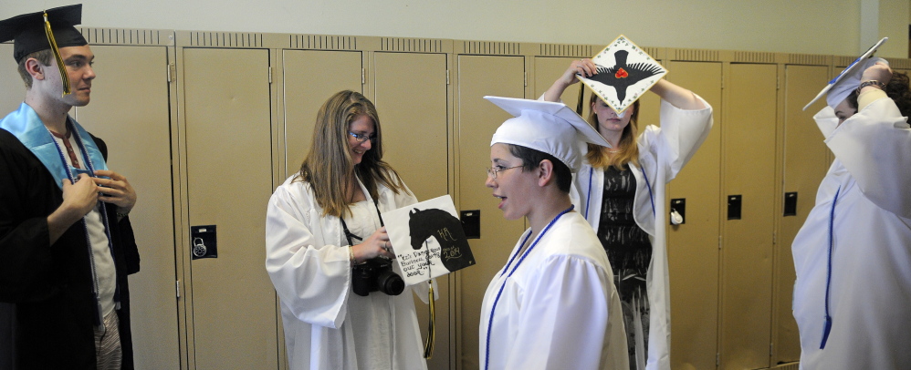 Staff photo by Andy Molloy Diploma time: Maranacook Community High School seniors don their robes Sunday before their commencement ceremony in Readfield.