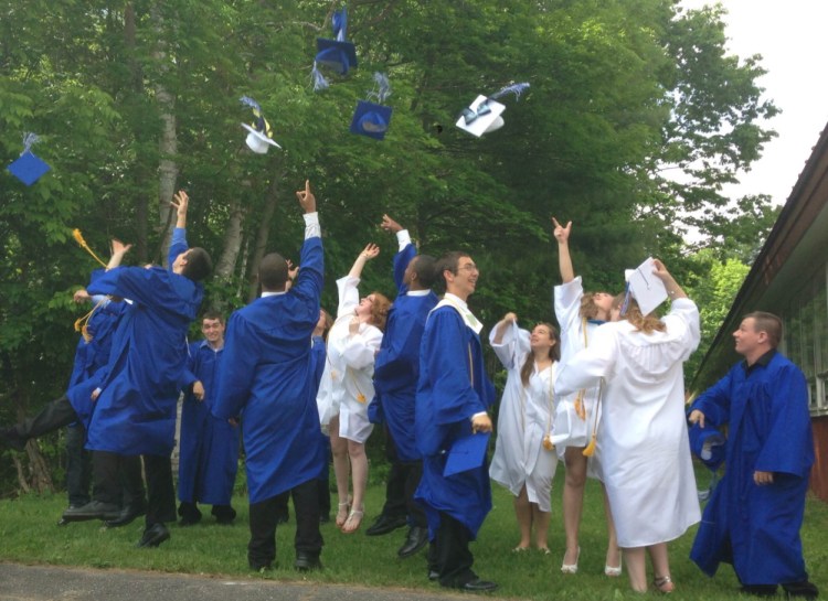 Staff photo by Jesse Scardina One last fling: Graduates of Upper Kennebec Valley Memorial High School toss their caps into the air Sunday after their commencement ceremony at the school in Bingham.