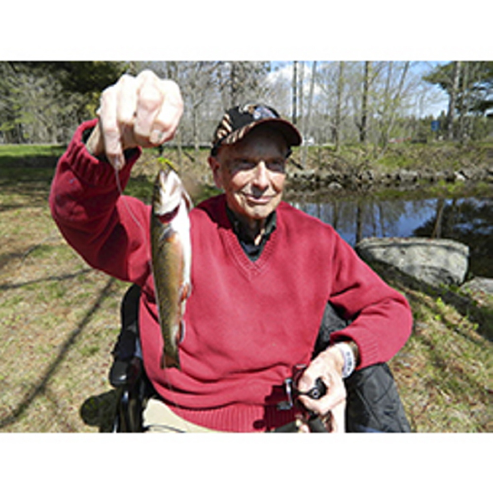 Photo by George Smith 
 STILL FISHING: Ezra Smith proudly holds a trout he caught recently from a small pond on the campus of the Veterans Affairs facility at Togus.