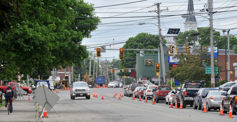 Staff photo by Michael G. Seamans TRAFFIC BACKUP: Traffic on College Avenue backs up behind gas line construction at the intersection of Main Street Tuesday.