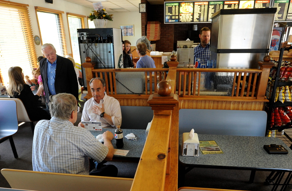 Campaign stop: Bruce Poliquin, left facing, Republican candidate for Maine’s 2nd Congressional District, speaks with the public during a visit to the Oakland House of Pizza, in Oakland, on Wednesday.