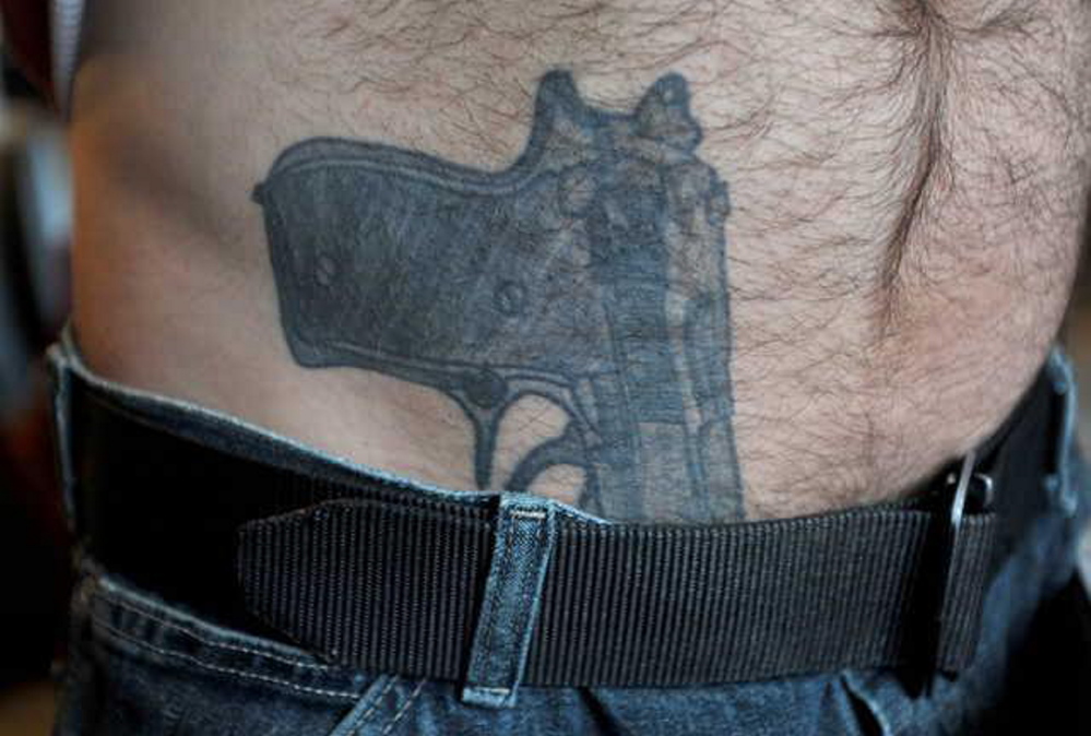 Tattoo:Close-up photo of Michael Smith’s gun tattoo, which prompted a call to police in March. Smith was arrested on drug charges Friday, and police say he had a real gun tucked in his waistband.