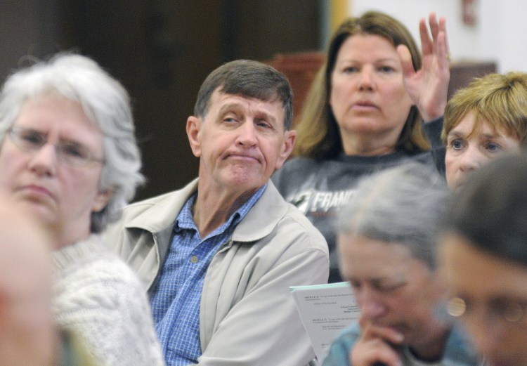 Voting: Residents of Fayette listen to a debate about an item on the warrant Saturday during Town Meeting.