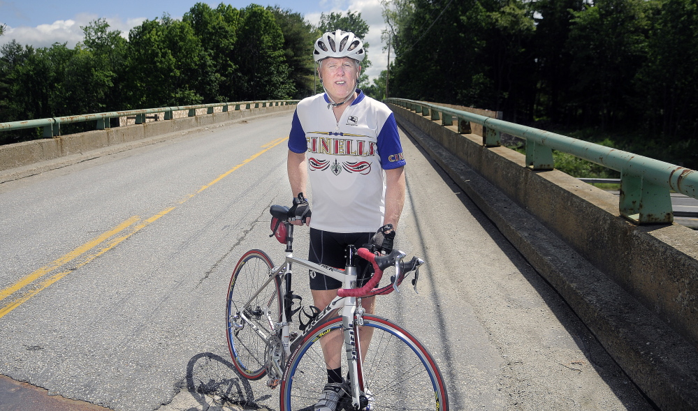 DETOUR: Patrick Gabrion of Hallowell rode on the overpass Sunday that spans the Maine Turnpike in Hallowell during his daily bike ride.