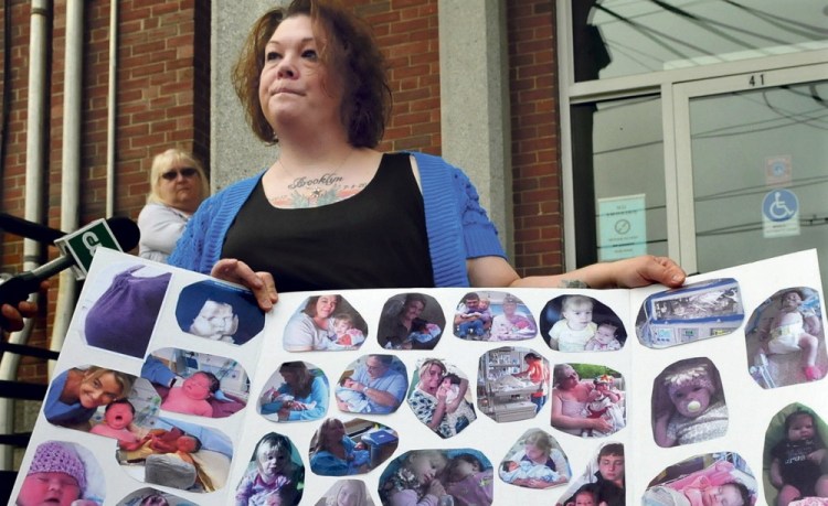 JUSTICE SOUGHT: Nicole Greenaway on Wednesday, May 21, 2014, holds a large poster with pictures of her infant daughter Brooklyn Foss-Greenaway on the steps of the Somerset Superior Court in Skowhegan shortly before hearings began that led to Kelli Murphy admitting to committing unspecified misdemeanors in the baby’s death.