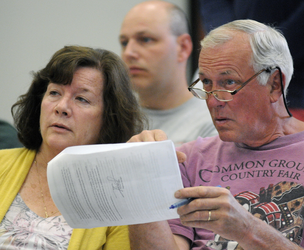 MOUNT VERNON: Geoffrey Herman and Susan Herman review an item on the Mount Vernon warrant Saturday, June 14, 2014, during the town meeting.