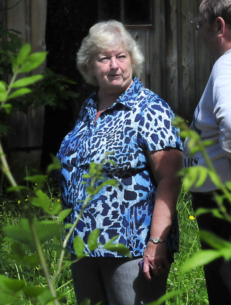 WHY: Homeowner Donna Brown speaks with a neighbor as firefighters extinguish the fire that erupted at her North Pond home where she was living on Wednesday. Brown said she did not know how the fire started.