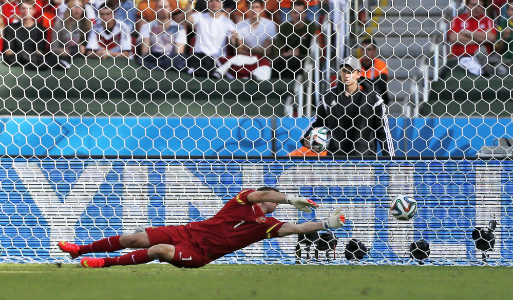 Australia's goalkeeper Mat Ryan fails to stop a shot by Netherlands' Robin van Persie to score his side's second goal during the group B World Cup soccer match between Australia and the Netherlands at the Estadio Beira-Rio in Porto Alegre, Brazil, Wednesday, June 18, 2014.  (AP Photo/Jon Super)