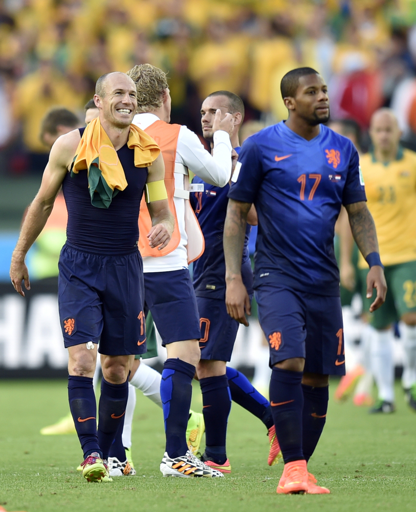 Netherlands’ Arjen Robben, left, smiles as he leaves the field after the group B World Cup soccer match between Australia and the Netherlands in Porto Alegre, Brazil, on Wednesday.