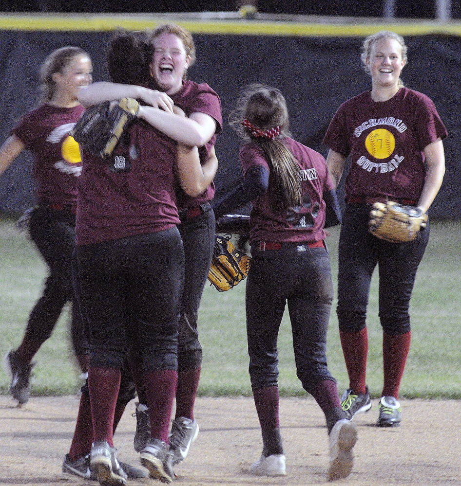 Richmond High School softball players celebrate their victory over Greenville High School at the end of the Western D softball final on Wednesday June 18, 2014 in Standish.