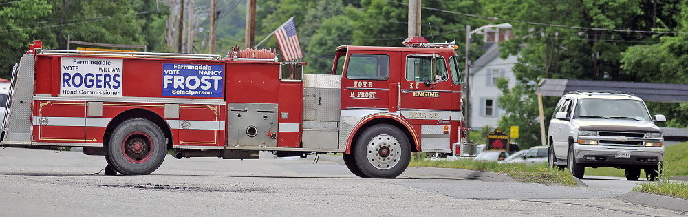 Town Election: A firetruck on U.S. Route 201 in Farmingdale is adorned with campaign signs for candidates for office in Farmingdale.