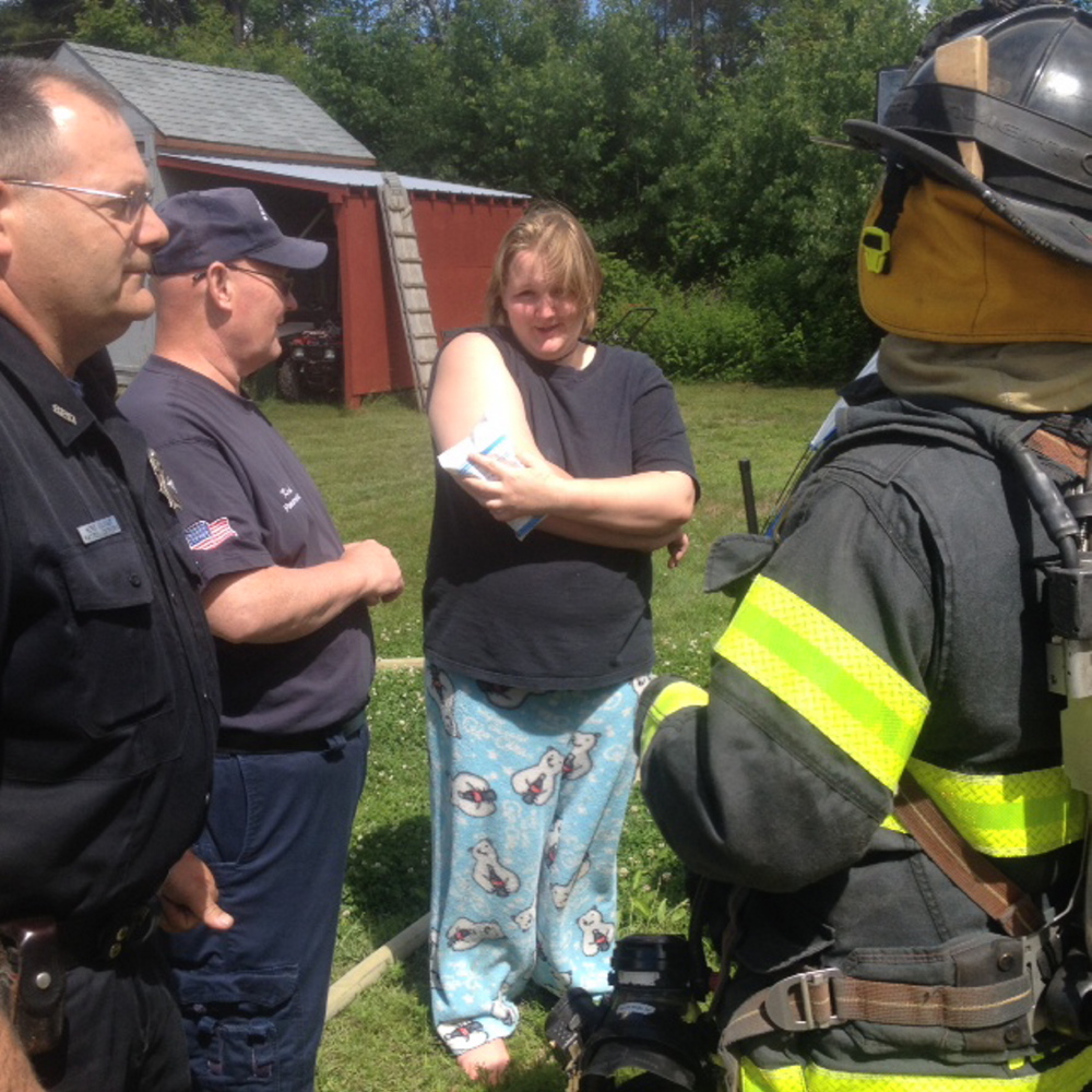 FIRE: Krista Corson, 19, holds a cold pack to minor burns she received when a grease fire ignited Friday morning at her home in Harvey’s Mobile Home Park in Skowhegan. Corson and three other teenagers reportedly escaped the fire with no other injuries.