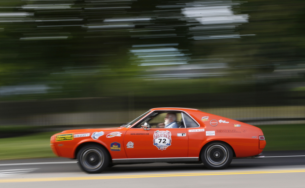 Marc Perlman of New Fairfield, Conn., driving a 1969 American Motors AMX, takes part in the Great Race road rally on Saturday. Officials say part of the challenge is following the instructions to win the race; the other challenge is finishing the race without any major mechanical breakdowns.