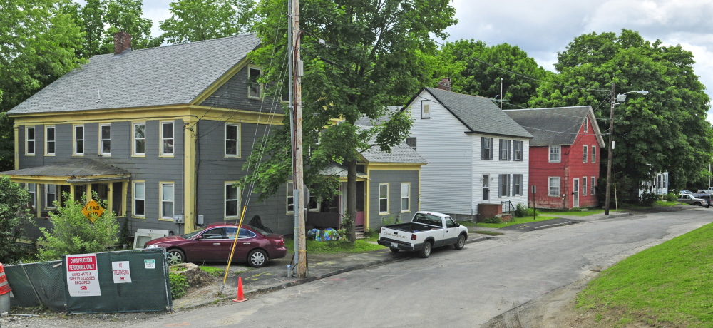 These four houses on Perham Street, shown on Wednesday, are near the new Kennebec County courthouse being built in Augusta and may be razed to make room for parking.