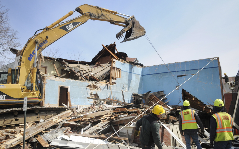 Workers with McGee Construction pulled down walls of the Masonic Lodge in Winthrop in April to make way for expansion of the Charles M. Bailey Public Library. To help pay for it, the Town Council plans to include $300,000 for the project in a larger bond encompassing other town needs.