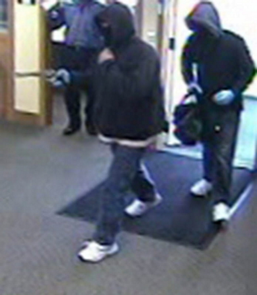 Two robbers are shown in a security camera image from Kennebunk Savings Bank on Oct. 19, 2013. Philip G. Gage was sentenced Monday for his role in this and other robberies.