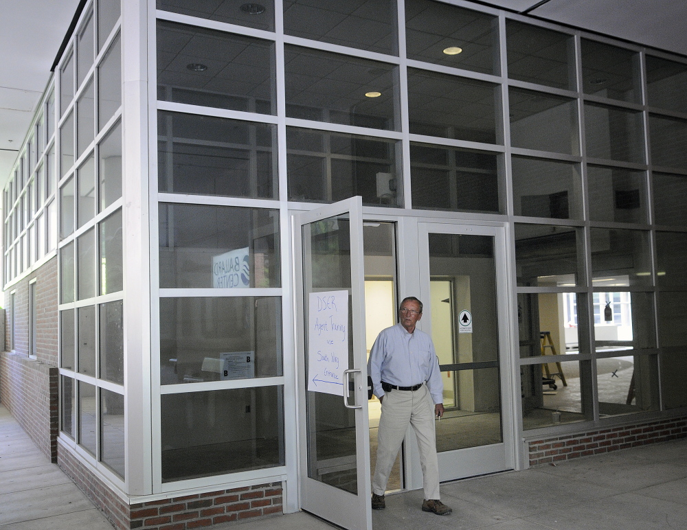 Bill Dowling of Mattson Development leaves the atrium entrance Monday of the former MaineGeneral hospital in Augusta. Redevelopment of the building on the east side of the Kennebec River in Augusta is going faster than expected, developer Kevin Mattson says.
