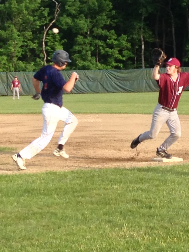 Staff photo by Matt DiFilippo 
 Post 51's Jake Dexter hustles to first as Franklin County first baseman Charlie Martin reaches for the throw during a Zone 2 game Monday night.