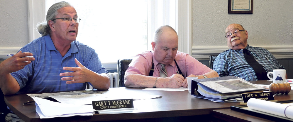 Franklin County Commissioner Gary McGrane, left, makes a point during a meeting Tuesday on the county’s bill for boarding out inmates at other jails in the state, as Commissioners Fred Hardy and Clyde Barker.