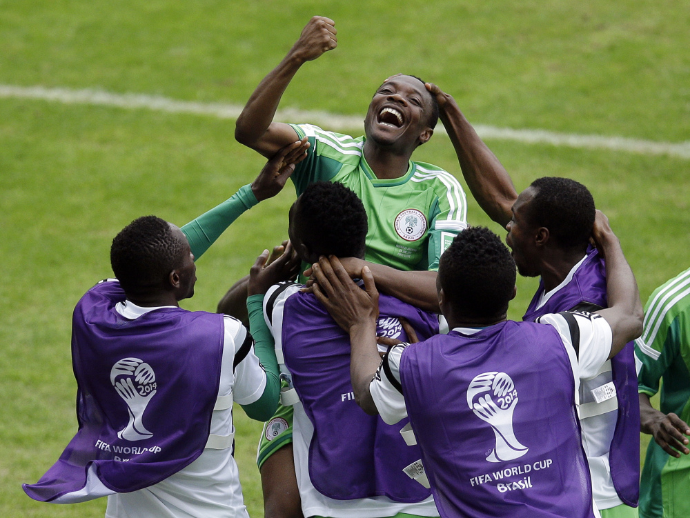 Nigeria's Ahmed Musa, center, celebrates with teammates after scoring his side's 2nd goal during the group F World Cup soccer match between Nigeria and Argentina at the Estadio Beira-Rio in Porto Alegre, Brazil, Wednesday, June 25, 2014. (AP Photo/Michael Sohn)