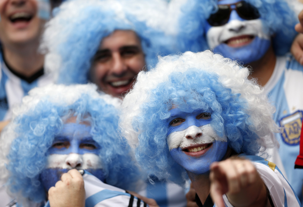 Argentina fans smile prior to the group F World Cup soccer match between Nigeria and Argentina at the Estadio Beira-Rio in Porto Alegre, Brazil, Wednesday, June 25, 2014. (AP Photo/Victor R. Caivano)