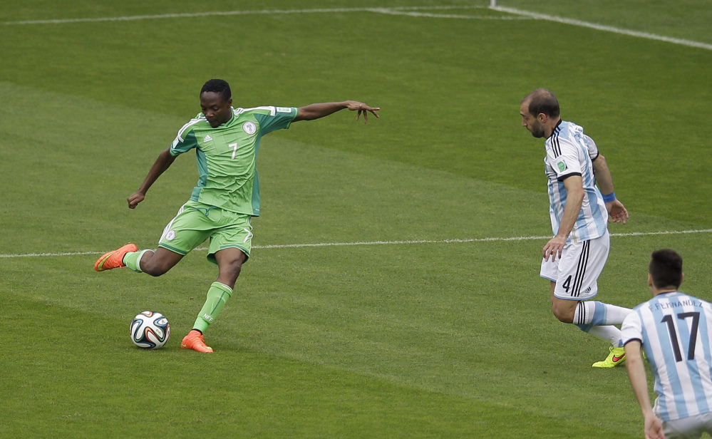 Nigeria's Ahmed Musa, left, scores his side's first goal during the group F World Cup soccer match between Nigeria and Argentina at the Estadio Beira-Rio in Porto Alegre, Brazil, Wednesday, June 25, 2014. (AP Photo/Michael Sohn)