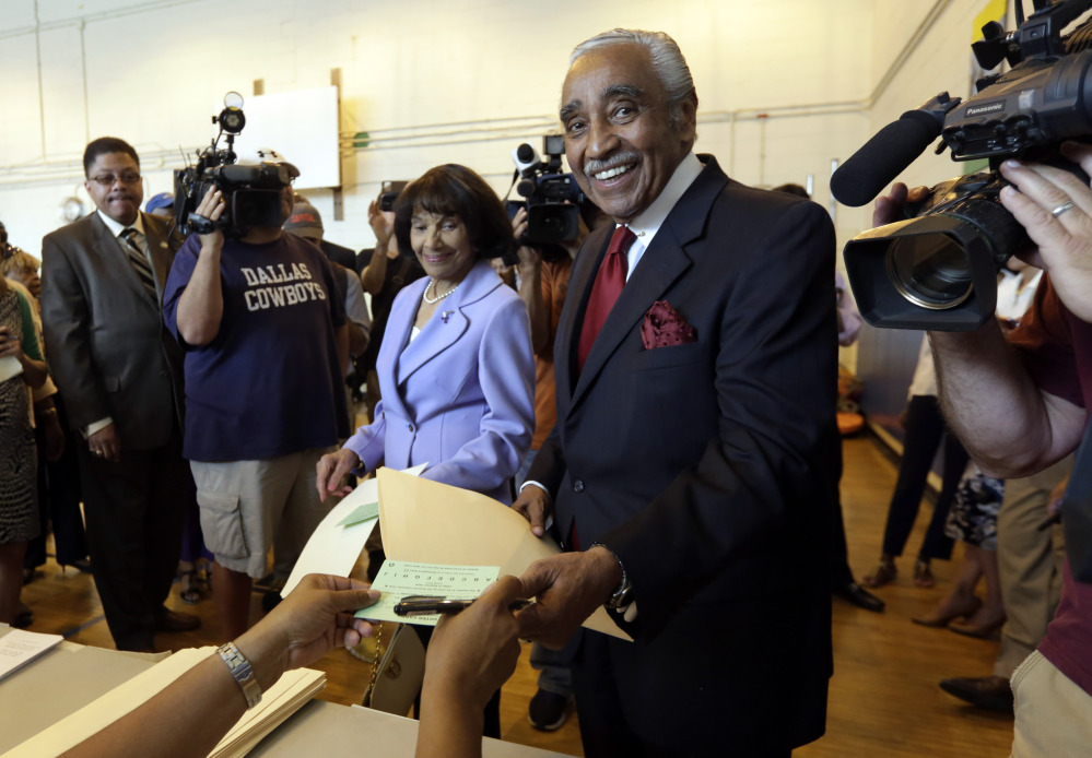 U.S. Rep. Charles Rangel, D-N.Y., accompanied by his wife, Alma Rangel, receives his ballot to vote in the congressional primaries Tuesday in New York.