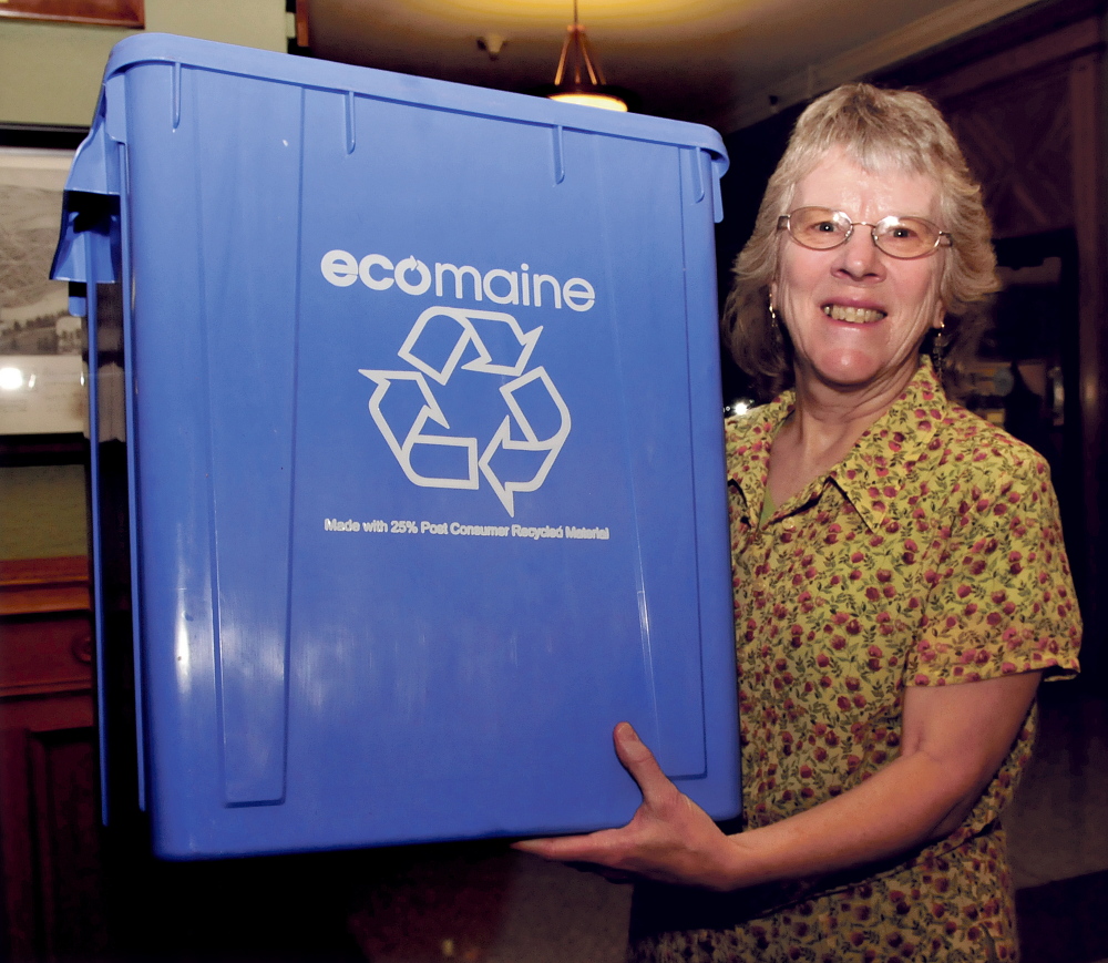 Linda Woods, a coordinator for Sustain Mid Maine Coalition, holds a recycling bin that will be available to residents for single-sort recycling. All recycleable materials will be tossed in the same bin. Some will be available Friday from 11 a.m. to 7 p.m. at Elm Plaza. Ecomaine will distribute the bins and offer advice on recycling.