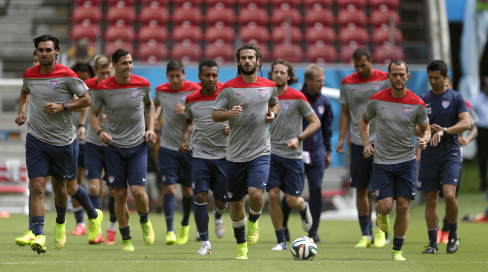 United States’ Kyle Beckerman, center, jogs with teammates during a training session Wednesday in Recife, Brazil.. The United States will play Germany today.