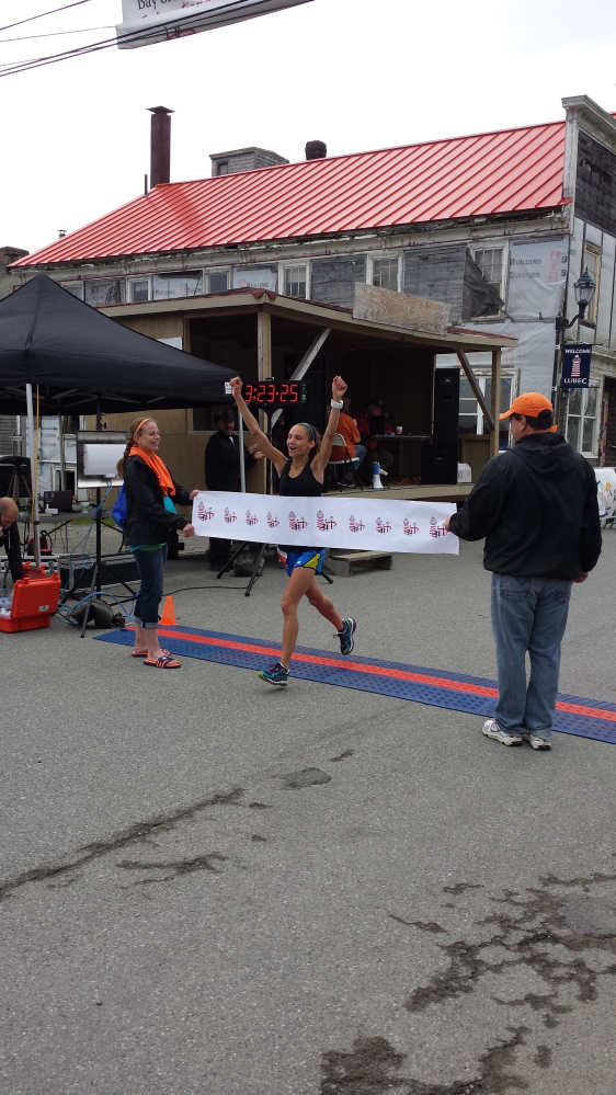 Courtesy photo 
 Lydia Kouletsis, 22, of Oakland, crosses the finish line at the Bay of Funday International Marathin in Lubec last month. Kouletsis was the top female finisher with a time of 3 hours, 23 minutes and 24 seconds