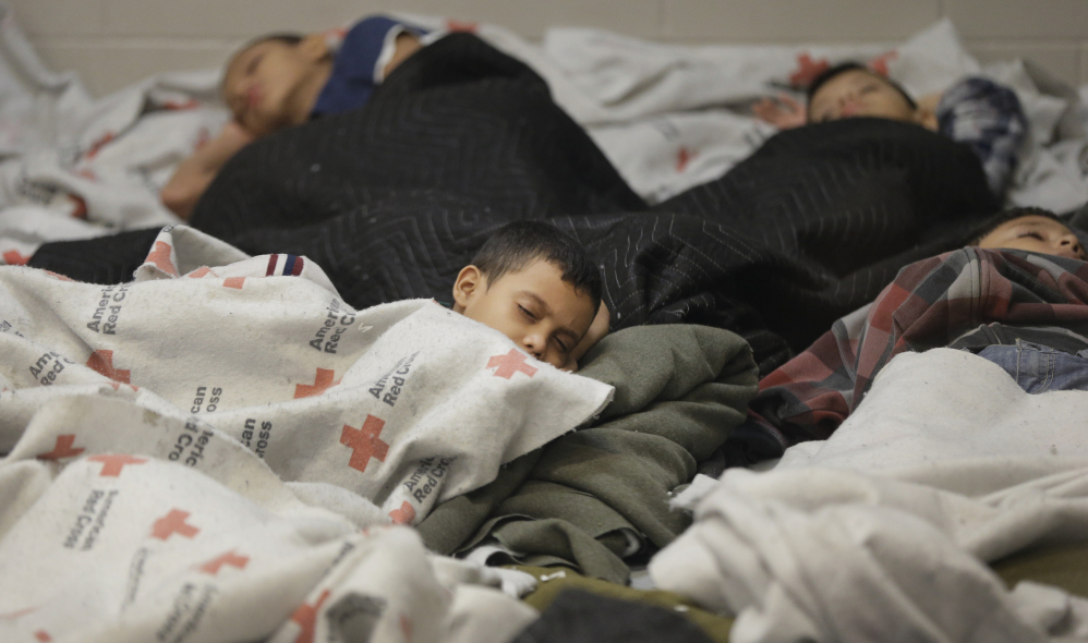 In this 2014 Associated Press photo, children detainees sleep in a holding cell last week at a U.S. Customs and Border Protection processing facility in Brownsville, Texas.