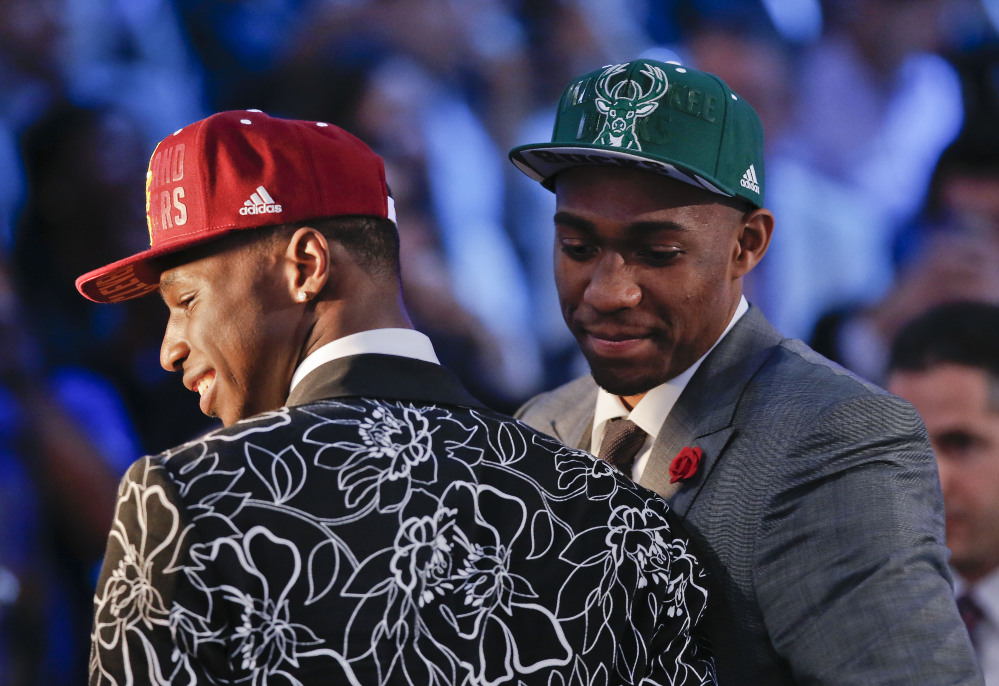 Andrew Wiggins, left, and Jabari Parker stop for television interviews after being selected as the top two picks in the 2014 NBA draft, Thursday, June 26, 2014, in New York. Wiggins was selected number one by the Cleveland Cavaliers and Parker was chosen number two by the Milwaukee Bucks.
