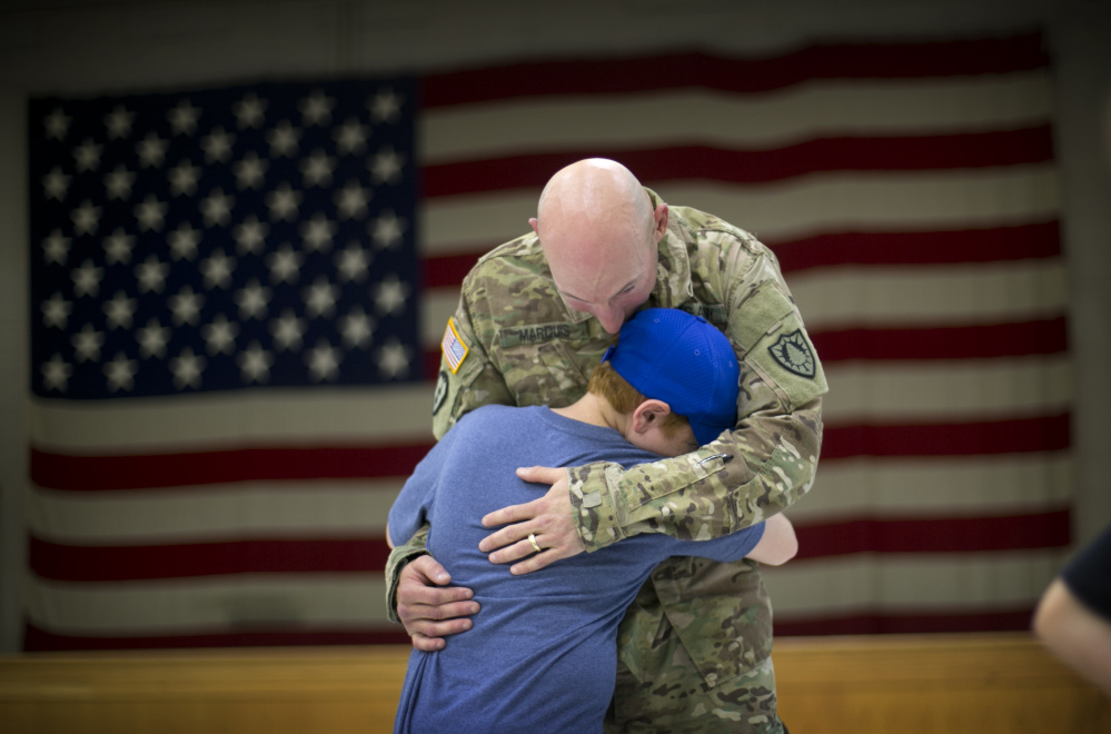 Andrew Marquis gets a hug from his nephew, Ryan Verrill of Lewiston, Maine, after members of the Maine Army National Guard’s 133rd Engineer Battalion returned home from Afghanistan on Friday in Augusta. Marquis, formerly of Lewiston, now lives in Boston, Mass.