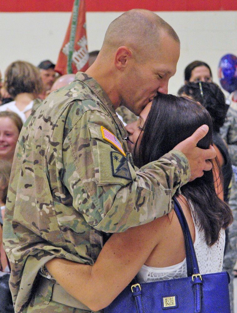 Staff Sgt. Todd Perkins kisses Nicole Mailhot, after he and the 1035th Survey and Design Team returned from a deployment in Afghanistan on Friday at the Augusta Armory.