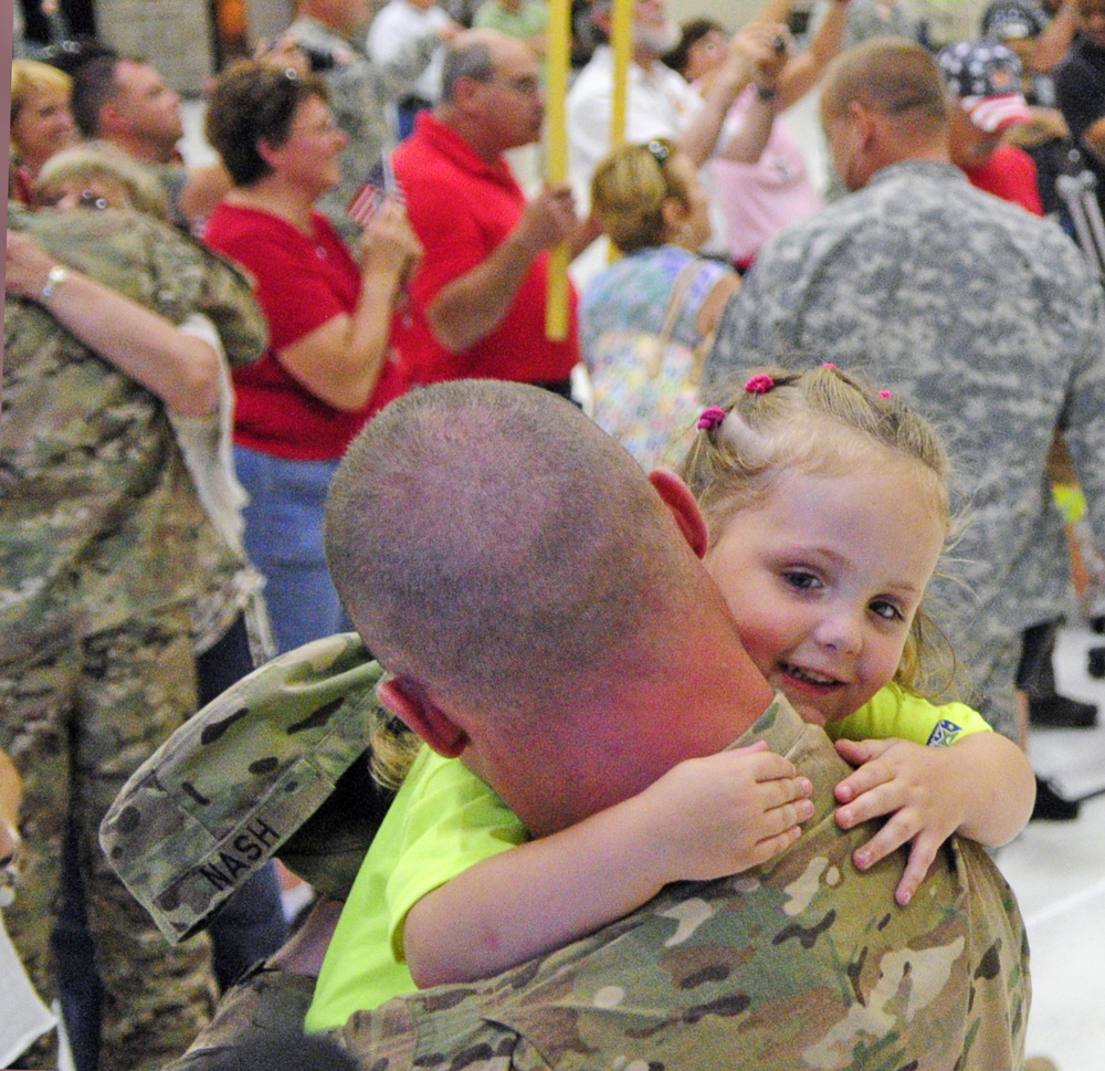 Sgt. Casy Nash, left, hugs his daughter Althea Nash on Friday at the Augusta Armory.
