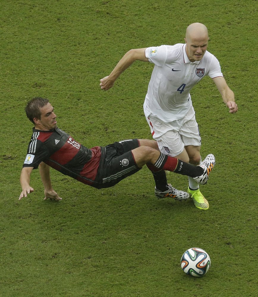 Germany’s Philipp Lahm challenges Michael Bradley (4) of the United States for the ball during a recent World Cup soccer match between the USA and Germany at the Arena Pernambuco in Recife, Brazil.