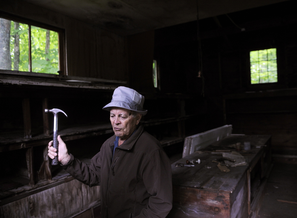 Lloyd McCabe, 90, repairs the former rabbit hutch Thursday that he recently purchased near his farm in Monmouth. McCabe plans to donate the small structure and the land along Mud Stream to the town for a park.