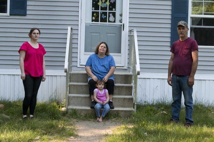 Wendy Brennan, center, outside her home with husband Peter, daughter Caitlyn and granddaughter Madelyn.