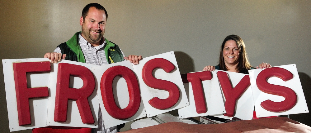 Staff photo by Joe Phelan New Shop: Nels Omdal, left, and Shelby Omdal hold up letters in 347 Water St. on Wednesday in downtown Gardiner. They’ll be opening a new Frosty’s Donuts there later this month. They said that the letters first hung in 1972 at the original Frosty’s in Brunswick.