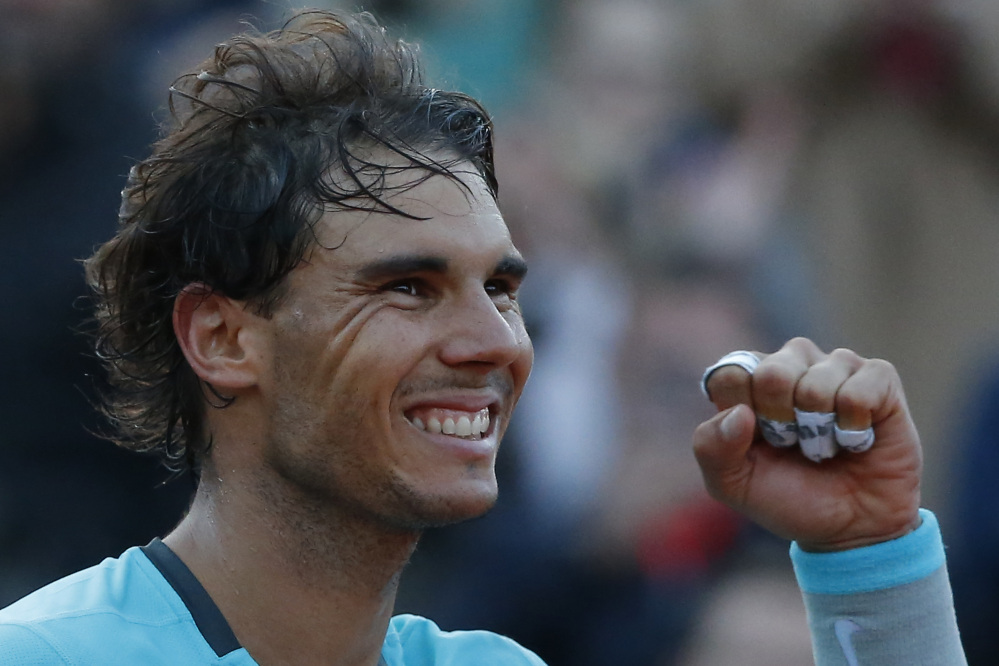 The Associated Press Spain’s Rafael Nadal celebrates winning the quarterfinal match of the French Open tennis tournament against compatriot David Ferrer in Paris, France, on Wednesday.
