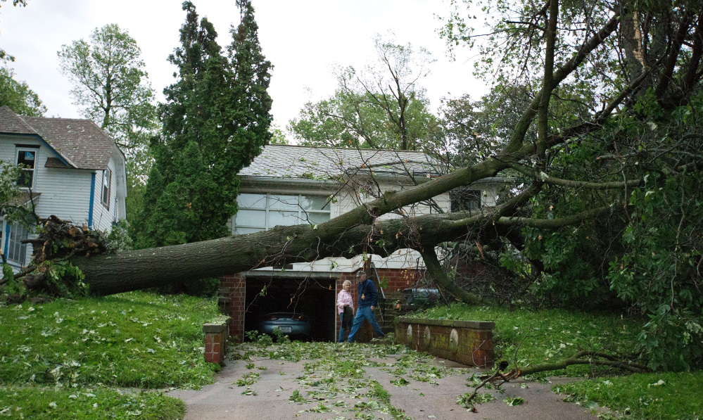 The Associated Press Dick and Laurel Rapp survey the damage to their home on Park Street in Oakland, Iowa, on Tuesday.