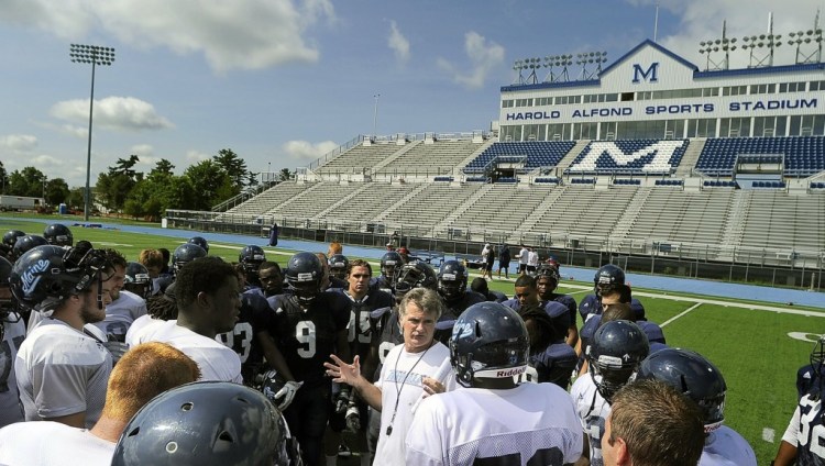 Black Bears head coach Jack Cosgrove speaks with his team at the end of a practice. The team was picked to finish seventh of 12 schools this season during the annual CAA media day. 2012 Press Herald File Photo/Gabe Souza