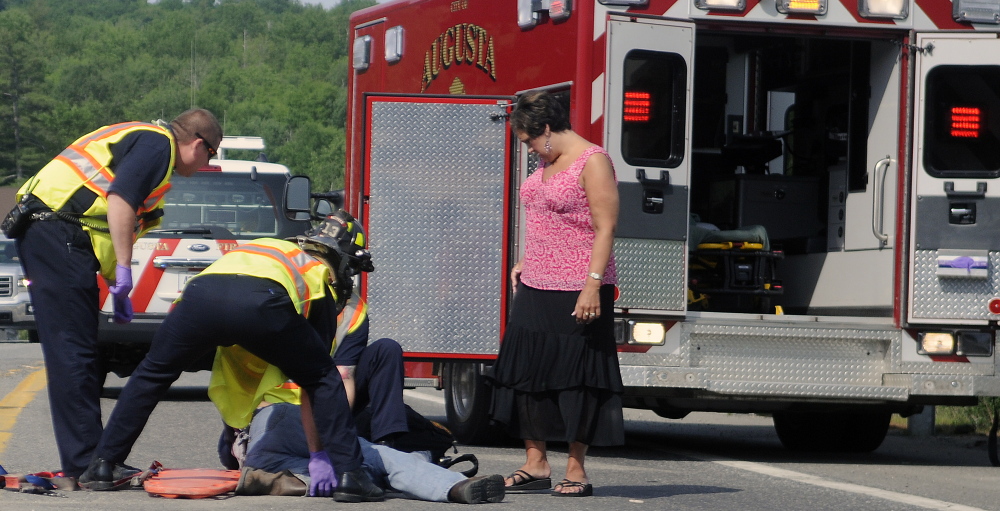 AUGUSTA, ME - City of Augusta paramedics treat a man Tuesday injured on an on ramp to Interstate 95 in Augusta.