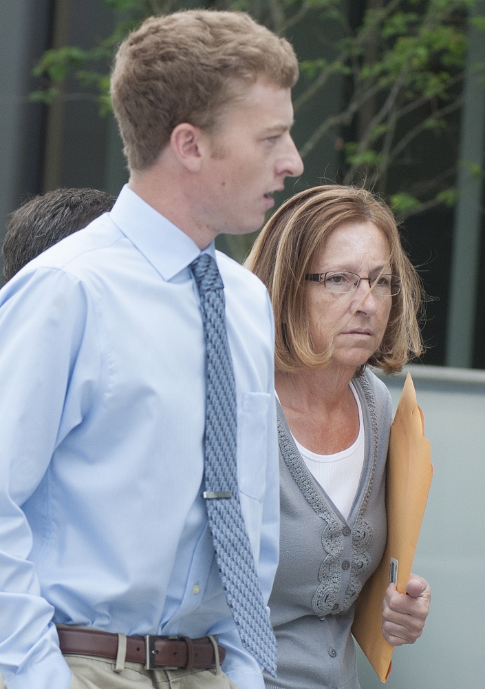 Carole Swan, former Chelsea selectwoman, with her younger son John Swan, as they enter the U.S. District Court building in Bangor June 13 for her sentencing hearing on extortion, tax fraud and workers compensation fraud.
