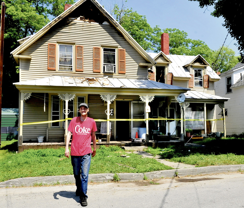 Steve Shorey on Wednesday walks away after looking at his neighbor’s home at 20 Milburn St. in Skowhegan that received extensive damage from fire on Tuesday evening. Shorey said that firefighters got the five tenants out and evacuated neighboring homes.