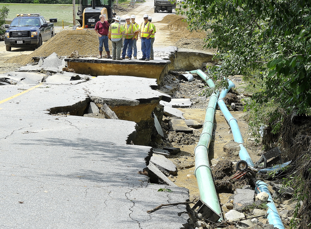 Maine Department of Transportation employees on Thursday inspect the damage caused by Wednesday night’s severe weather at South Rumford Road in Rumford.
