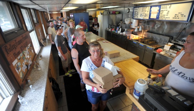 A line stretches out the door Thursday at Bolley’s Famous Franks on College Avenue in Waterville. The landmark lunch destination served its last hot dog Thursday, ending a 52-year run.