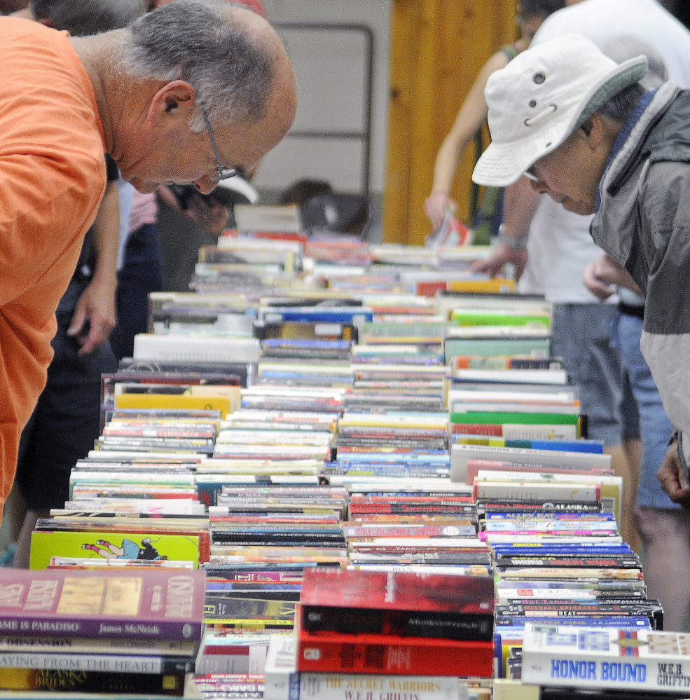 Visitors at the Center For All Seasons in Belgrade browse books for sale. While some of the town’s Fourth of July events were postponed because of rain, the Belgrade Public Library’s annual book sale went off without a hitch, though it was moved into the center from outdoors in the village.