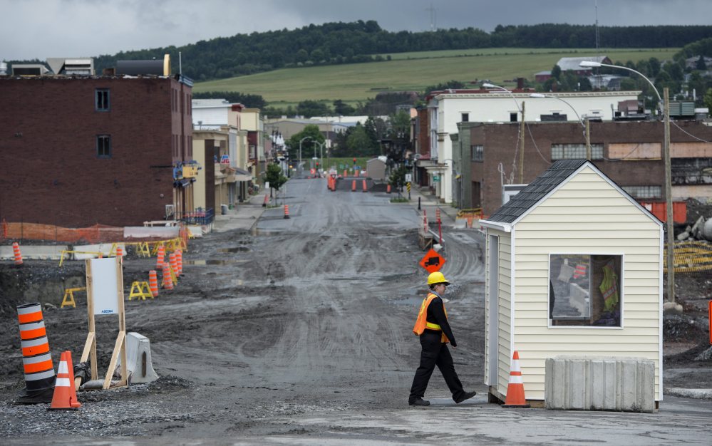The main street of Lac-Megantic, Quebec, remains closed Friday, July 4, 2014. A year has passed since a runaway oil train slid quietly down a hill in the middle of the night and derailed in a series of explosions that obliterated a large swath of downtown Lac-Megantic, killing 47 people. Paved roads and new buildings remain a long way off in the fenced-off disaster zone. The damage to the surrounding river system hasn’t been fully made public, and the environmental cleanup alone will cost at least $200 million.