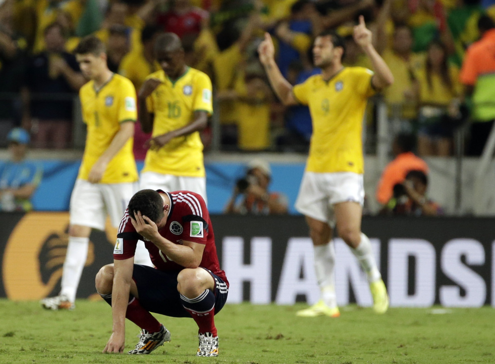 Colombia’s James Rodriguez hangs his head in disappointment at the end of the World Cup quarterfinal soccer match between Brazil and Colombia on Friday at the Arena Castelao in Fortaleza, Brazil. Brazil won the match 2-1.
